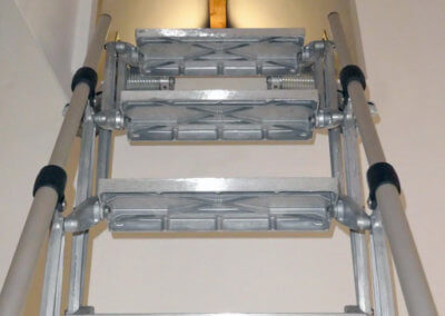 Elite Vertical heavy duty loft ladder extended from wall hatch. Premier Loft Ladders