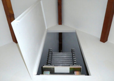 Elite Vertical space saving loft ladder in folded position within wall hatch. Premier Loft Ladders