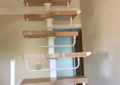Final phase of loft conversion staircase installation with handrails being fitted. Premier Loft Ladders