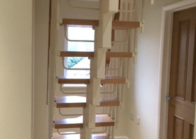 Compatta loft conversion stairs, featuring white powder coat steel structure. Premier Loft Ladders