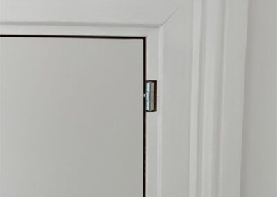 Installed loft eave doors finished with period architrave.