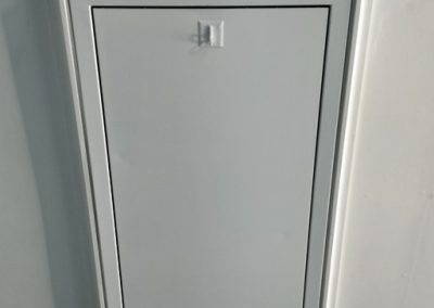 Fire-rated loft hatch, with decorative architrave and white painted finish to match interior décor.
