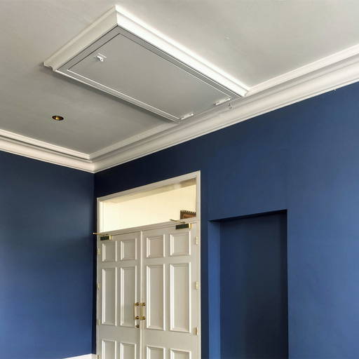The fire-rated hatch was installed with decorative architrave and painted white to match the décor of the hall.