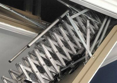 Heavy-duty aluminium retractable ladder with electric operation.